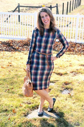 a reviewer wearing the dress in blue