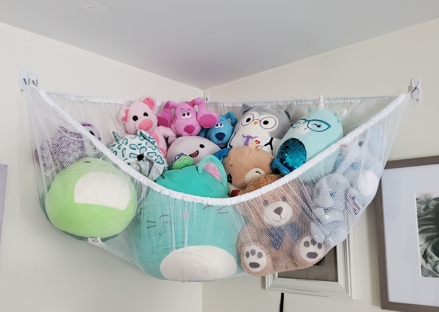 Reviewer photo of toy storage hammock full of stuffed animals