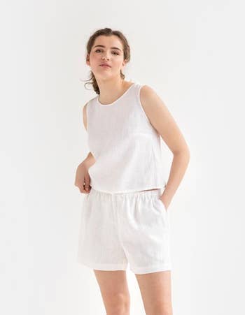 model wearing the white shorts with a white tank