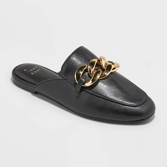 the black slip-on mules with gold chains across the top