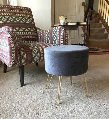 a reviewer's grey ottoman in front of a chair