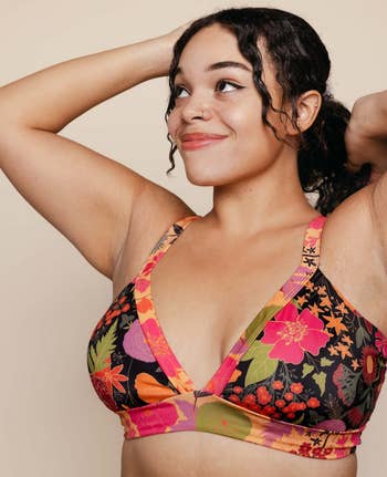 a model poses in a floral V-neck swim top 