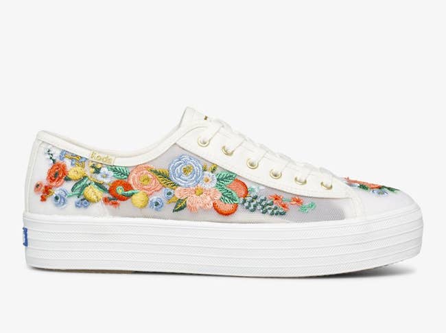 white platform lace up sneakers with sheer sides embroidered with colorful flowers