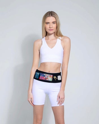 model wearing the PocketCor in black, showing how it fits stuff inside