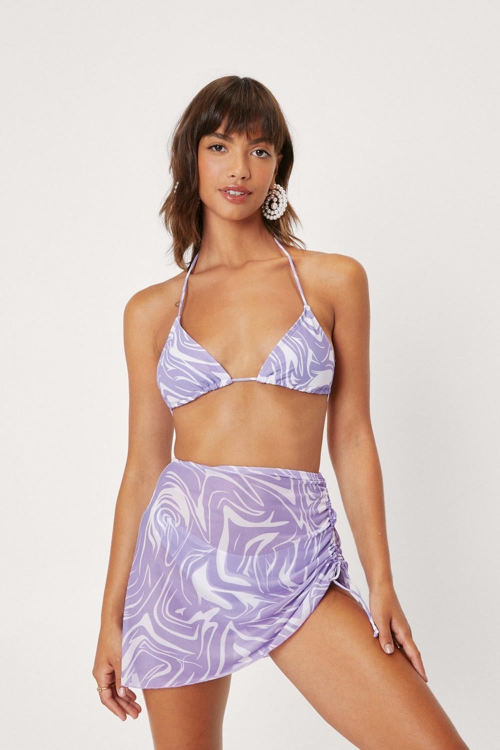 A model in the triangle suit with miniskirt coverup