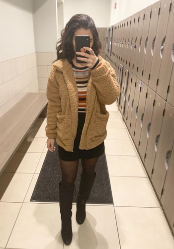 Daily News | Online News reviewer wearing the brown teddy coat with a skirt and tights