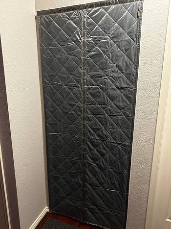 Quilted doorway screen installed successful a hallway, utilized for draught extortion and insulation