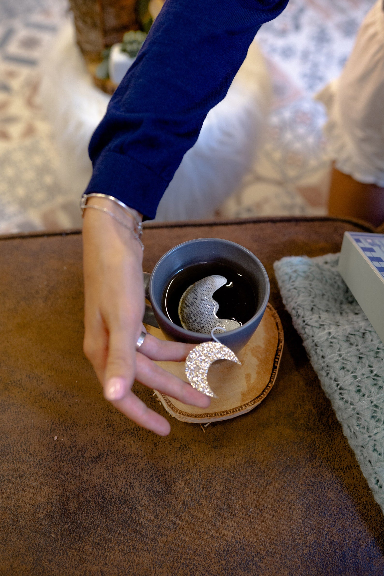 the moon shaped tea bag in a mug full of tea