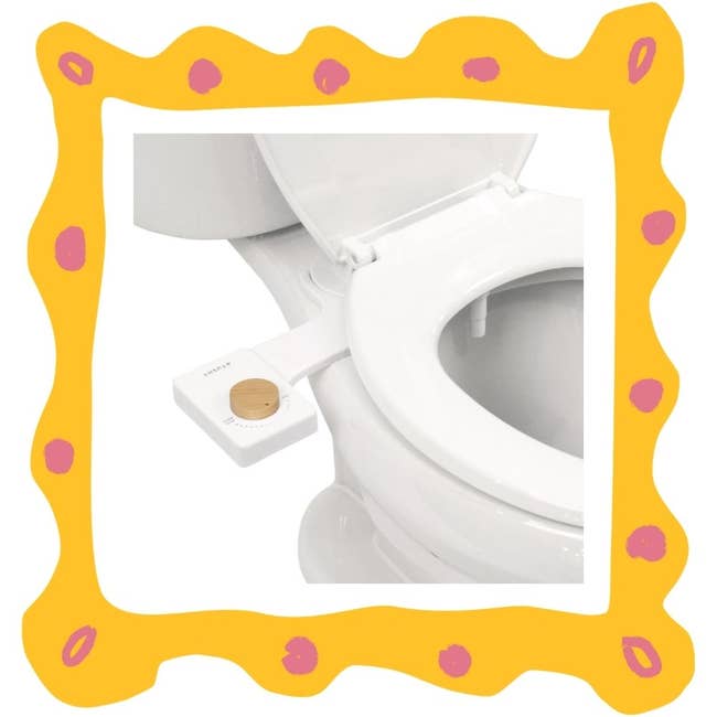 Toilet with attached bidet sprayer shown
