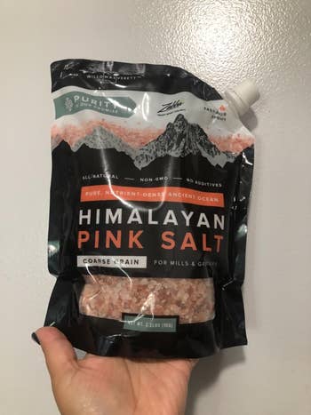 reviewer holding the bag of Himalayan pink salt