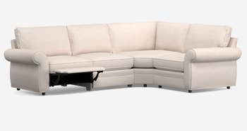 lifestyle image of white rolled-arm sectional with reclining footrest