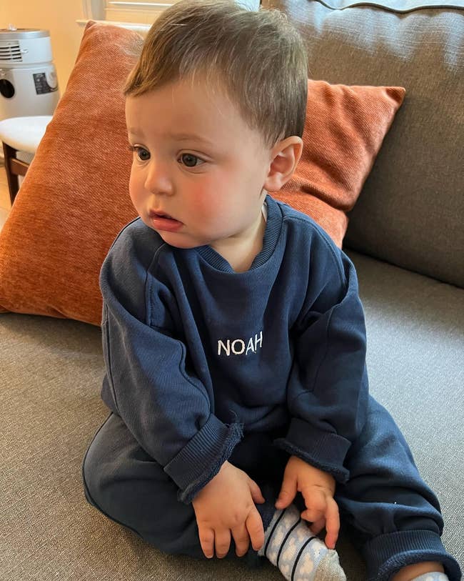 buzzfeed editor's toddler in a matching navy blue sweat set with his name embroidered on the shirt