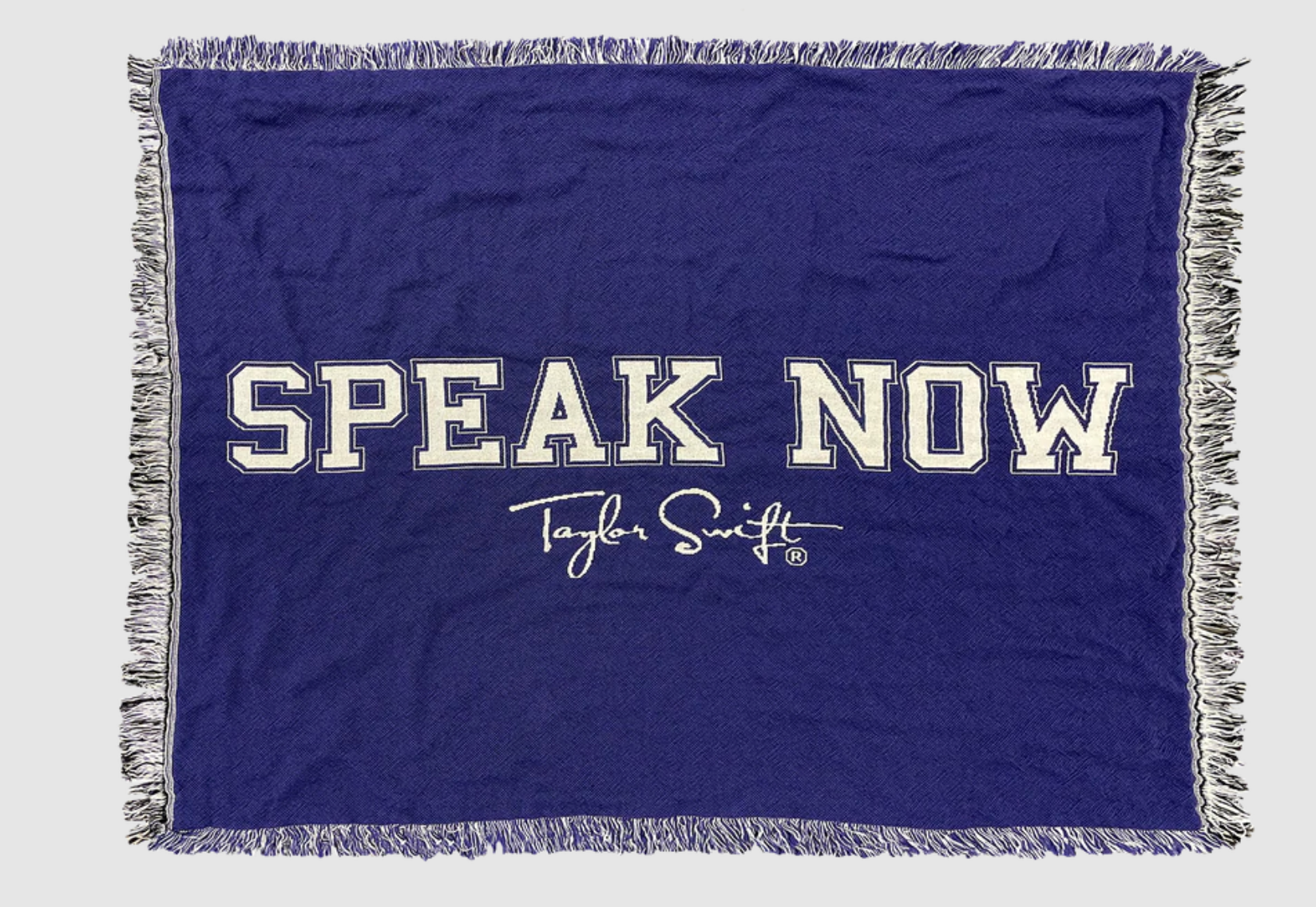 purple woven blanket that reads speak now taylor swift in white text on it 