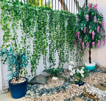 reviewer photo of the garland hung on a tall outdoor wall
