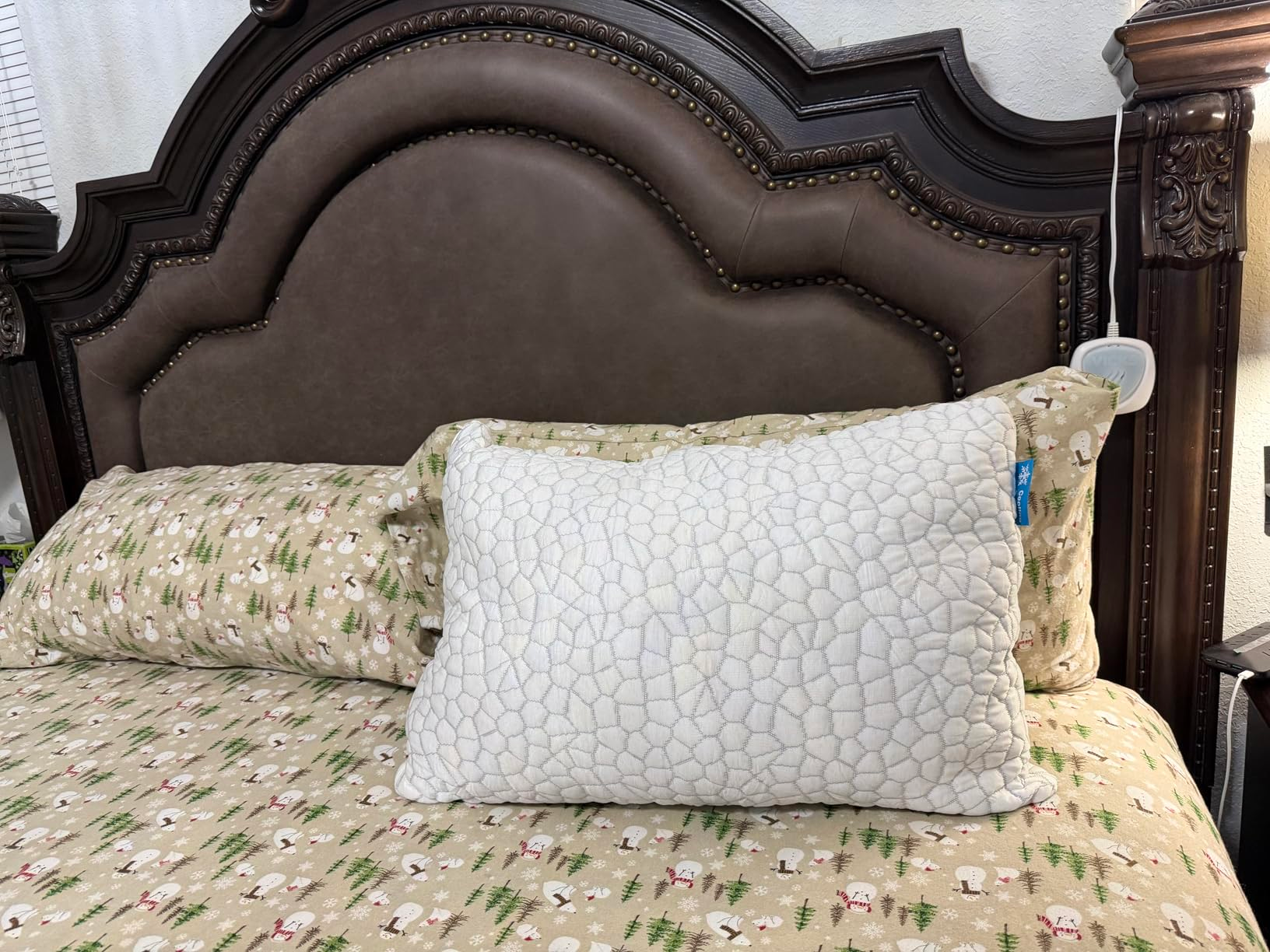 A neatly made furniture  features a plush, textured pillow connected  patterned sheets with a woodland theme, acceptable   against a woody  headboard
