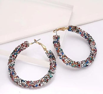 a pair of chunky rainbow glitter hoop earrings