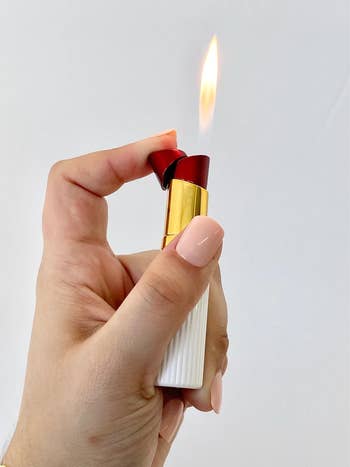 The top popped off a lipstick tube to show the open flame 