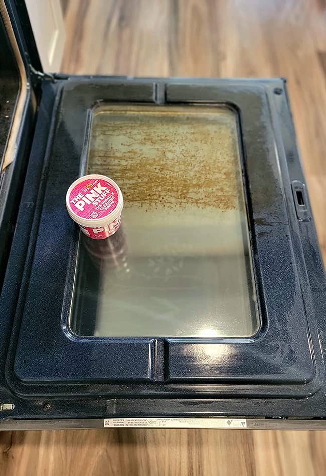 A reviewer's oven showing half of it clean where they used the Pink Stuff