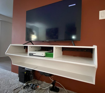 Floating TV stand with charging station at the bottom