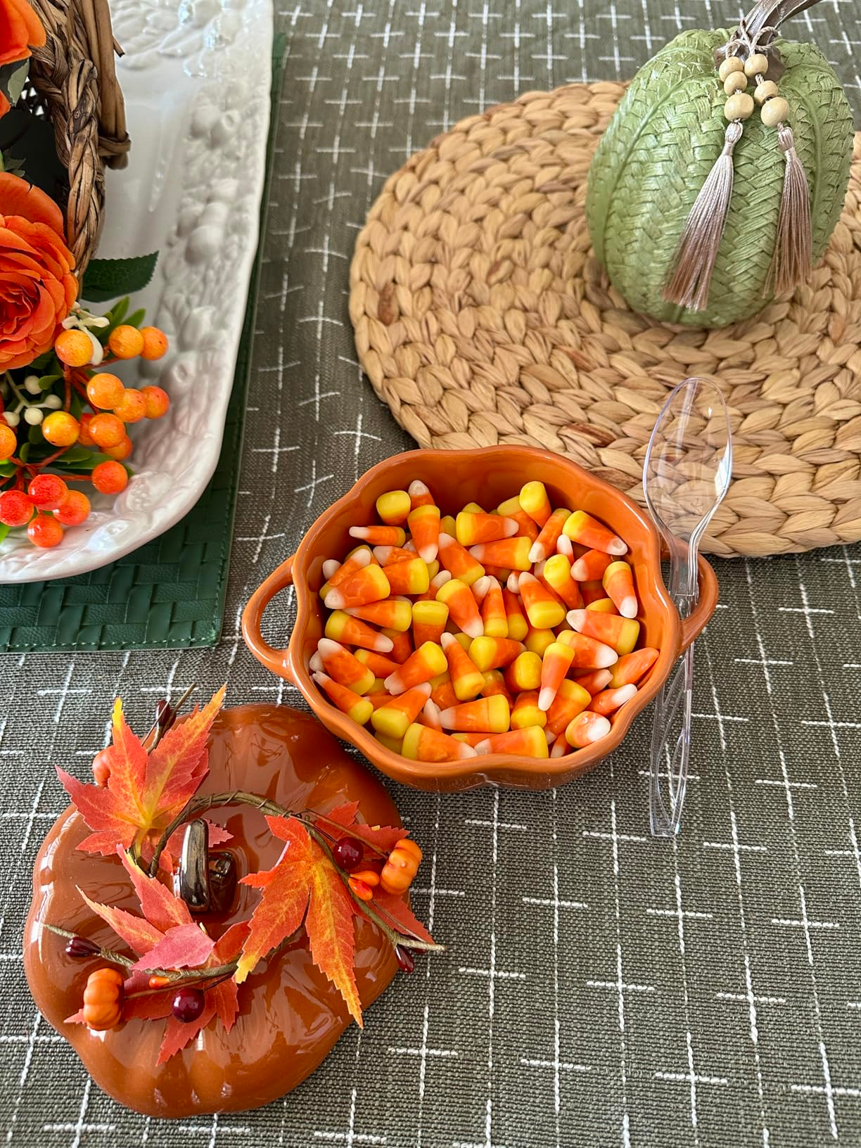 Candy corn and fall-themed decor set on a table 