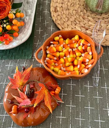 Candy corn and fall-themed decor set on a table