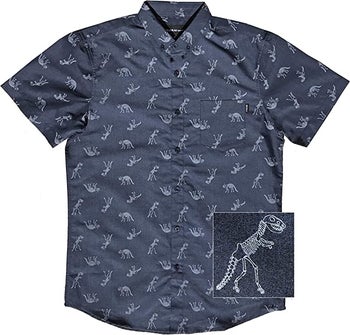 A blue short sleeved button down dotted with T-Rex skeletons