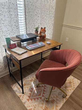 A reviewer's pink chair in their work setup