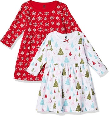 two long sleeve dress one red with snow flakes one white with colorful trees on it