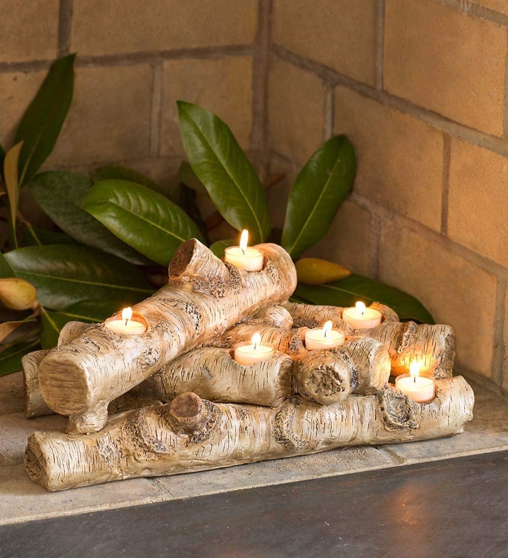 faux wood logs with holes filled with tea light candles 