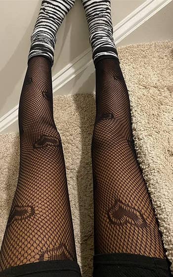 reviewer wearing black hearts tights