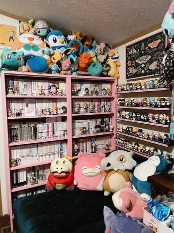 Bookshelf filled with manga and various plush toys 