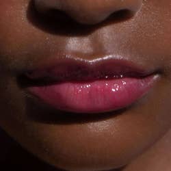 close-up of model wearing ultra-pigmented pink lip gloss