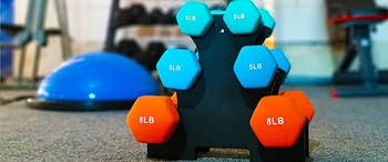 set of dumbbells on the rack, on the floor of a gym