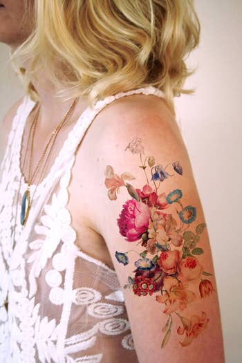 Model with a floral tattoo on their upper arm 
