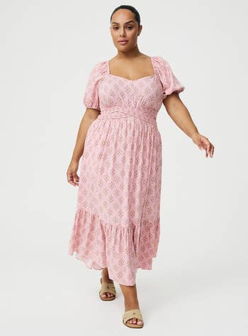 Model wearing a floral-patterned formal with puff sleeves and sandals, suitable for a casual oregon buying day