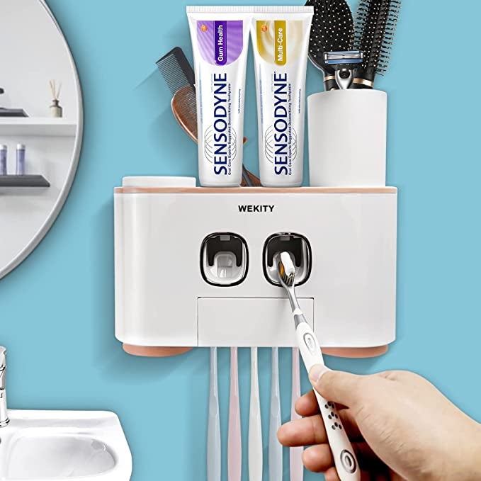 Model holding toothbrush up to automatic toothpaste dispenser