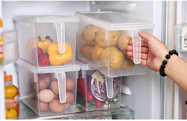four stacked bins in a fridge