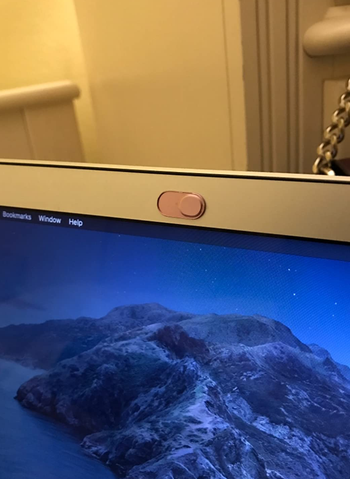 Reviewer's pink webcam cover, closed so that the camera is hidden