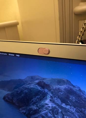 Reviewer's pink webcam cover, closed so that the camera is hidden