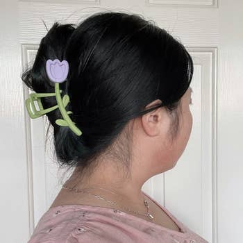 person modeling the purple claw clip in their hair holding it up