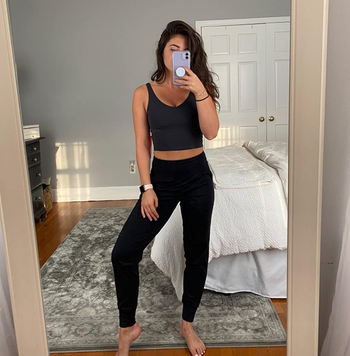 reviewer wearing the black joggers