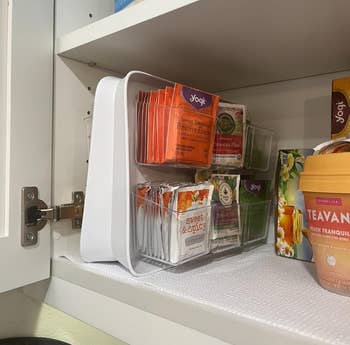 reviewer's slim double-sided tea organizer in a cabinet