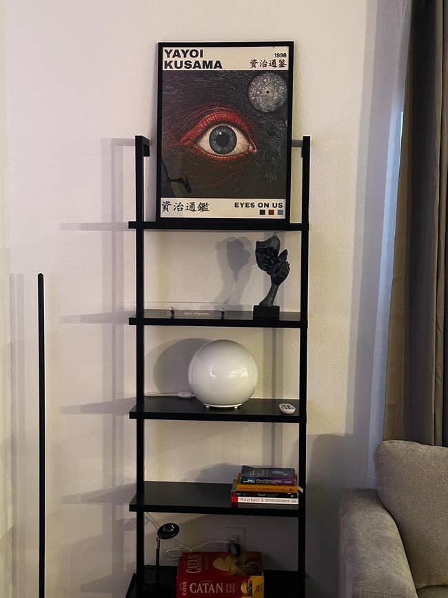 A reviewer's Shelf with art poster titled