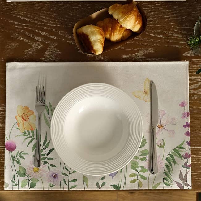 plate and utensils on placemat with flowers and butterflies