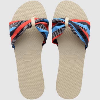 the shoes featuring a tan sole and multicolored stripe strap 