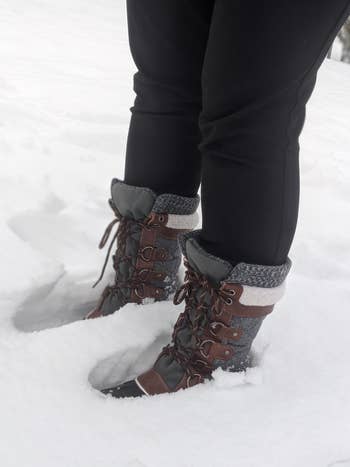 reviewer standing in snow in the boots