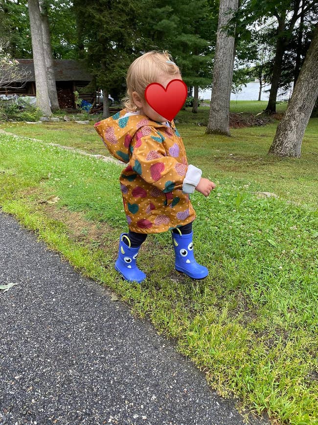 image of reviewer's child wearing the heart-covered windbreaker