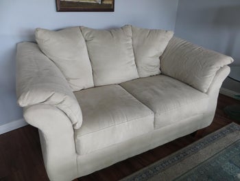 reviewer photo of their plain sofa before putting on the slipcover