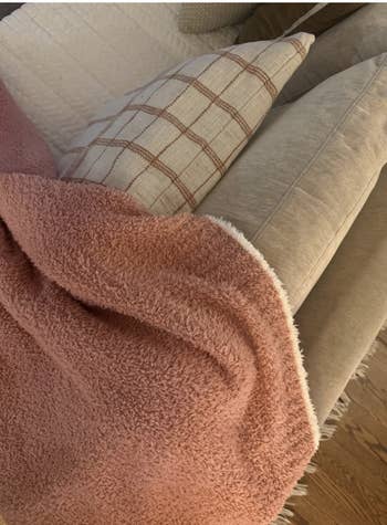 Cozy surviving country with patterned pillows and a textured, brushed broad connected a beige couch, suggesting a comfy buying choice