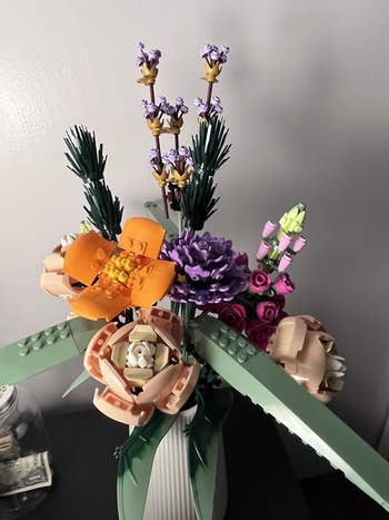 Lego floral bouquet statement successful a vase, featuring assorted intricate bloom designs made of interlocking integrative pieces